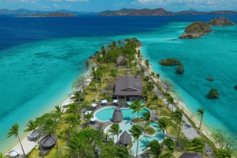 Vista aérea del Two Seasons Coron, con sus piscinas y sus palmeras en una estrecha franja de tierra entre dos playas